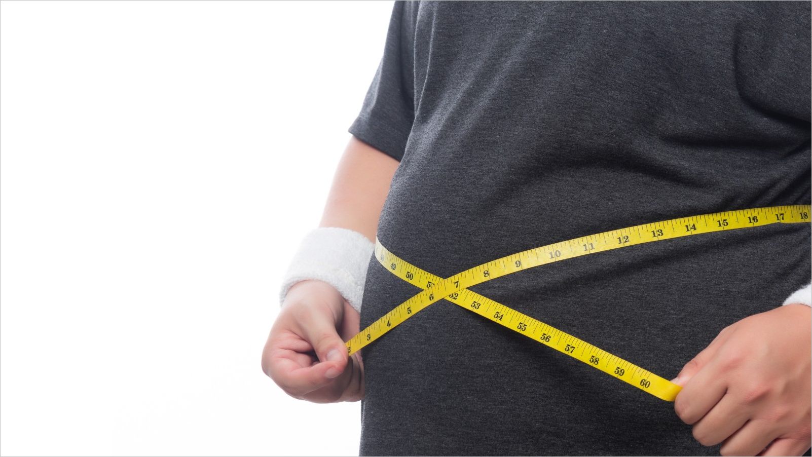 Obese person measuring their waist