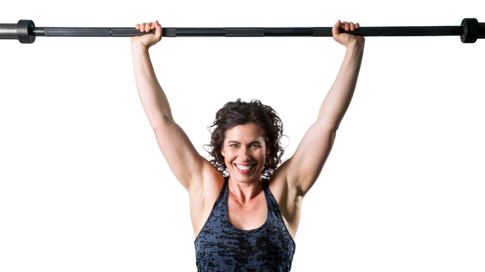 Woman in fitness attire lifting a barbell overhead