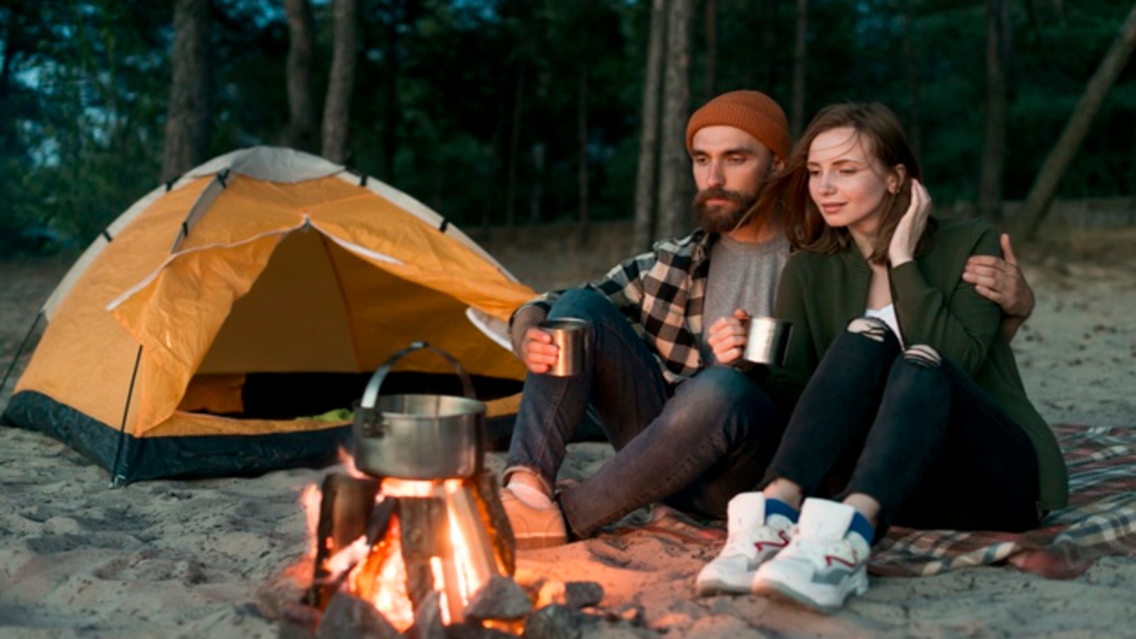 couple sitting by campfire