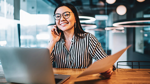 Female accountant sitting at desk with laptop