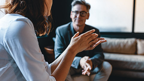 Colleagues sitting in an office discussing business