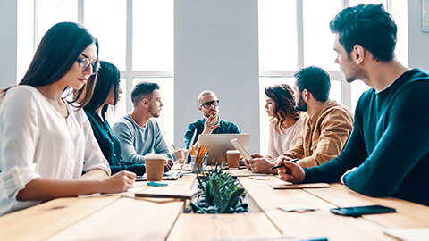 Group of work colleagues meeting around a large table