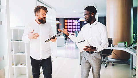 2 male coworkers discussing safety related matters in a modern office