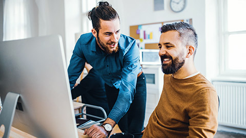 Colleagues looking at a desktop computer