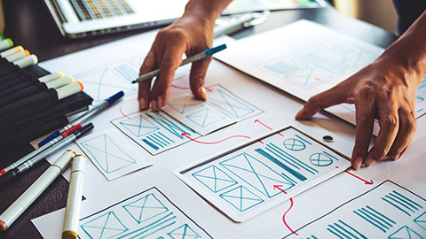 UX designer drawing diagrams on a desk